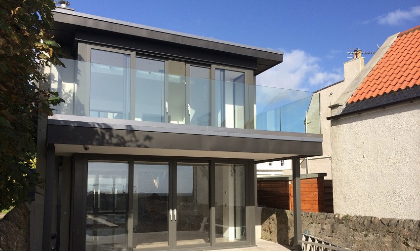 two storey home with glass doors and balustrade