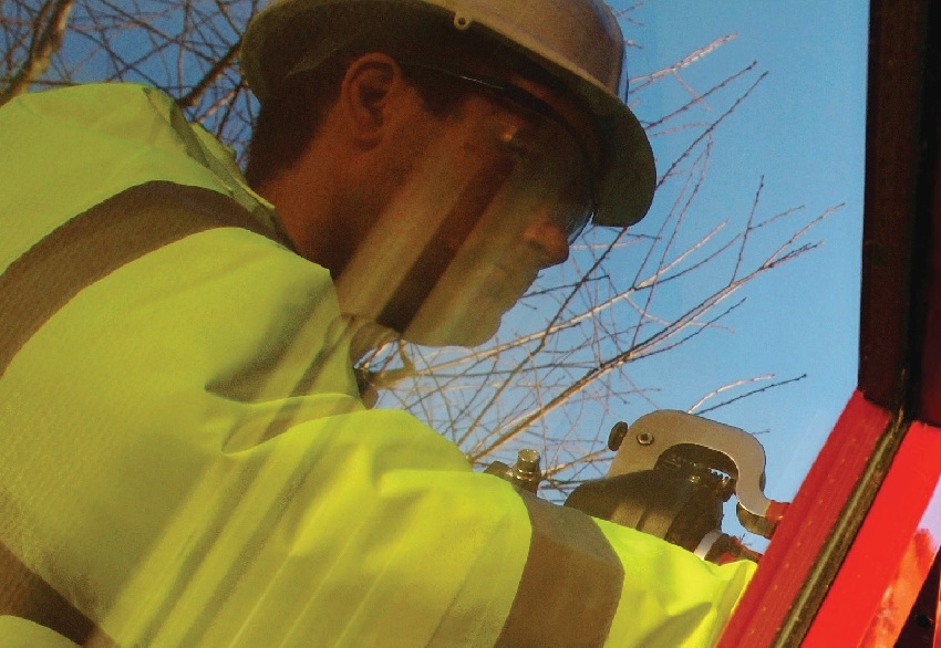 glazier repairing glass with hi-vis vest